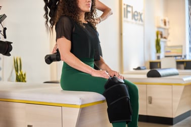 woman getting an assisted stretch using recovery tools at iFlex Stretch Studios