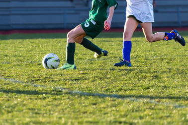 2 soccer players playing on the field in peak performance due to their recovery routine