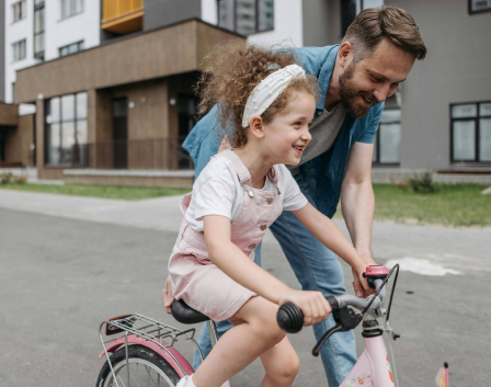 Man with daughter on bike